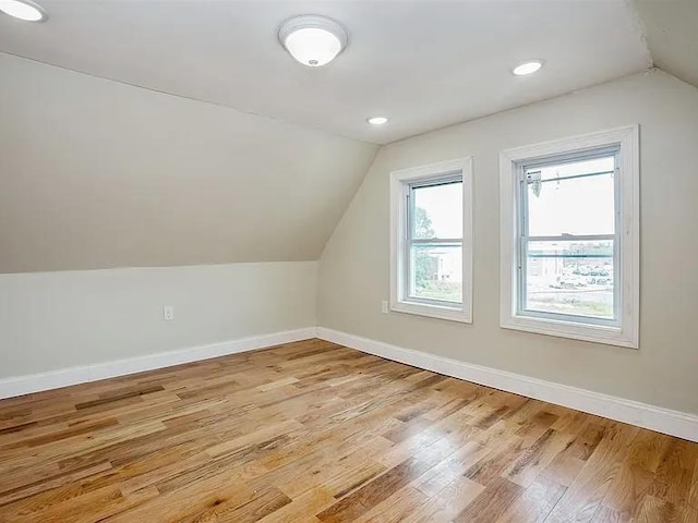 additional living space featuring lofted ceiling, recessed lighting, light wood-style floors, and baseboards