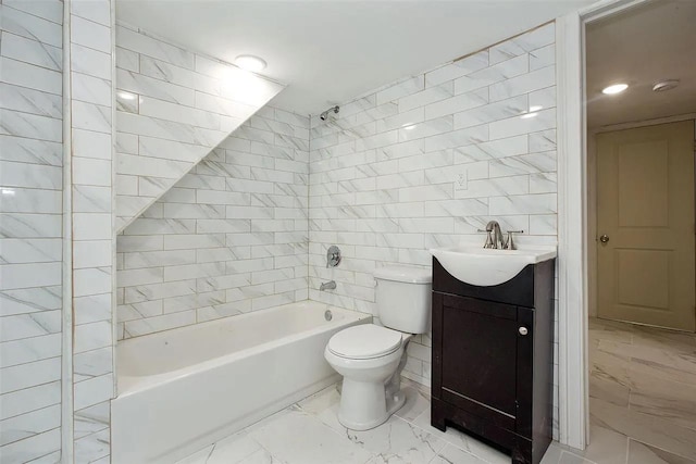 full bath with tile walls, toilet, bathtub / shower combination, marble finish floor, and vanity