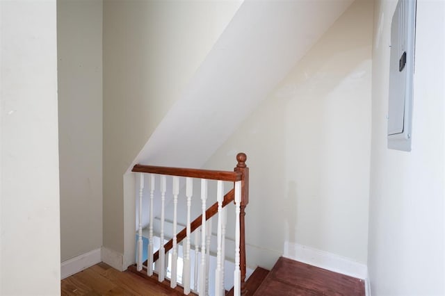 stairway featuring baseboards and wood finished floors