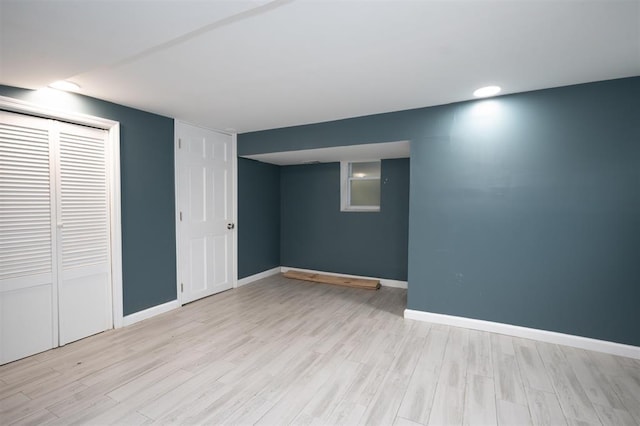 finished below grade area featuring light wood-style floors and baseboards