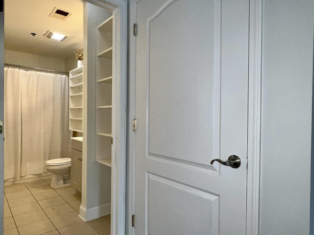 bathroom with curtained shower, visible vents, toilet, and tile patterned floors