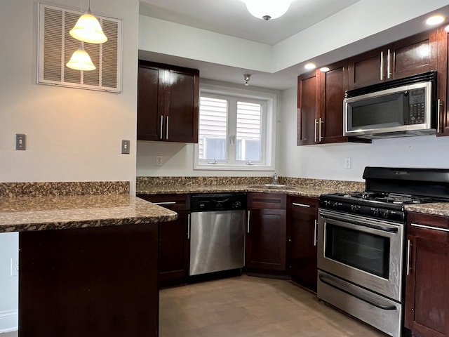 kitchen featuring appliances with stainless steel finishes, visible vents, dark brown cabinetry, and a peninsula