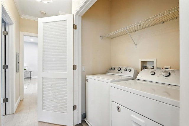 126 Dudley St Unit 315, Jersey City, NJ 07302 - laundry room featuring separate washer and dryer, light wood finished floors, and ornamental molding