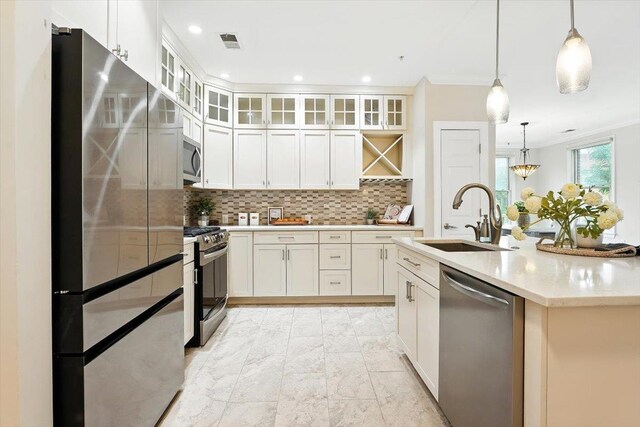 126 Dudley St Unit 315, Jersey City, NJ 07302 - kitchen featuring stainless steel appliances, tasteful backsplash, white cabinetry, light marble finish floors, and ornamental molding