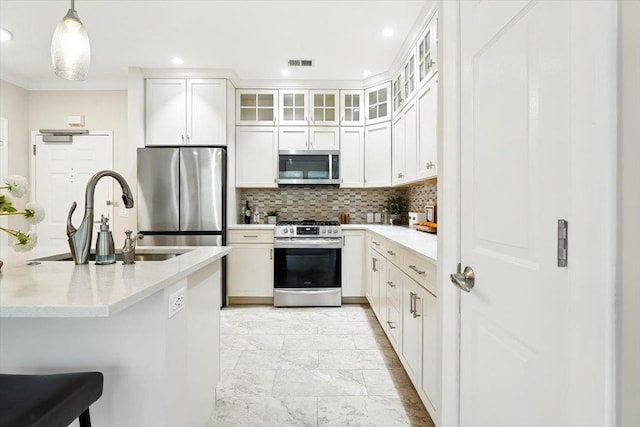 126 Dudley St Unit 315, Jersey City, NJ 07302 - kitchen with appliances with stainless steel finishes, light marble finish floors, tasteful backsplash, pendant lighting, and white cabinetry