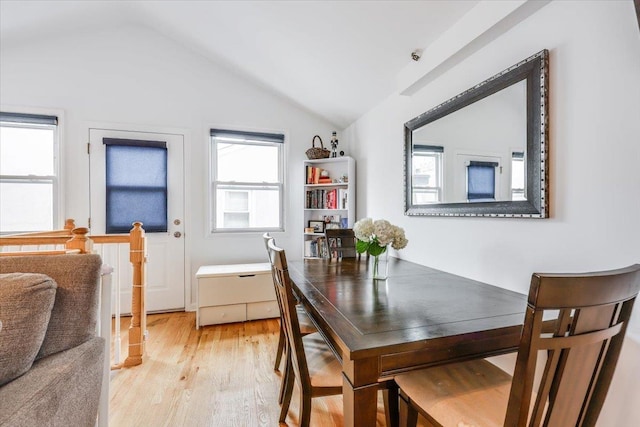 dining room with lofted ceiling and light hardwood / wood-style floors