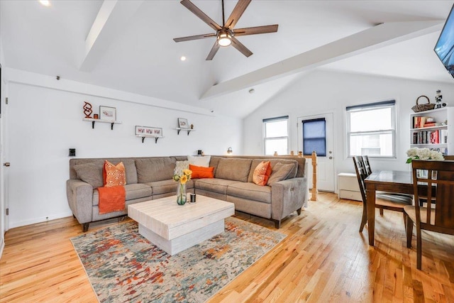 living room with light hardwood / wood-style flooring, vaulted ceiling, and ceiling fan