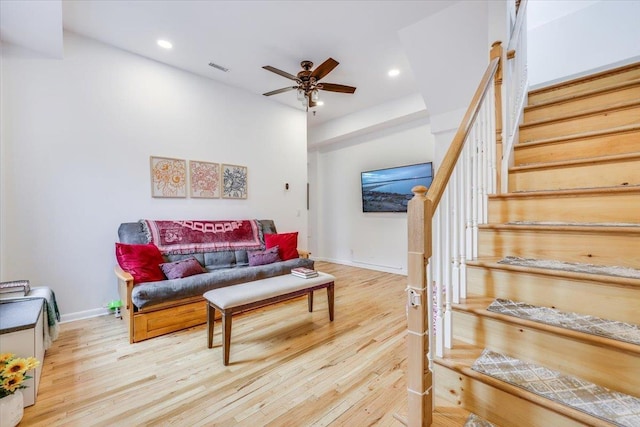 living room featuring ceiling fan and light wood-type flooring