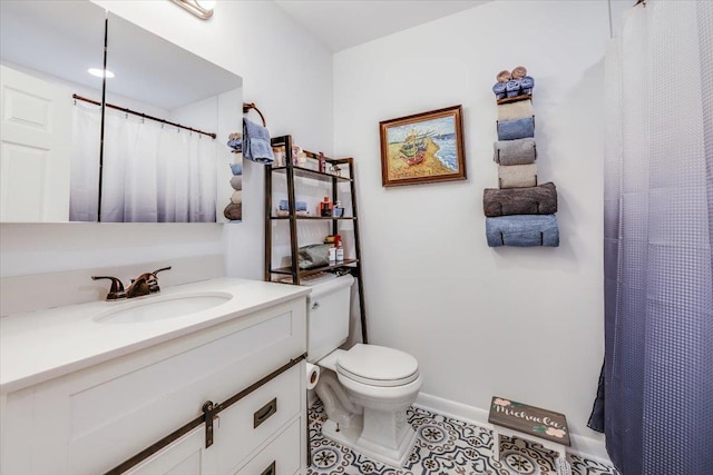 bathroom featuring vanity, tile patterned floors, and toilet