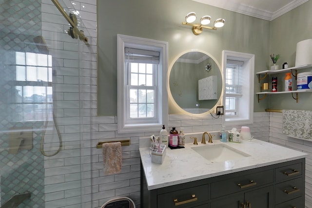 bathroom with tile walls, vanity, ornamental molding, and a tile shower