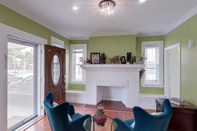 interior space with a fireplace, light hardwood / wood-style floors, a chandelier, and crown molding