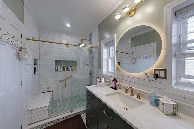 bathroom with vanity, decorative backsplash, a shower with door, and ornamental molding