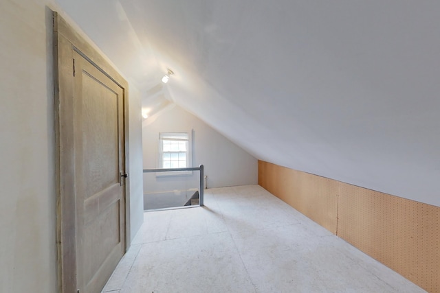 additional living space featuring lofted ceiling