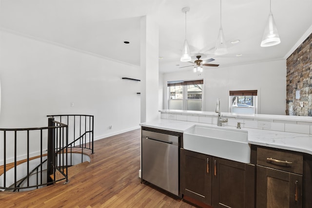 kitchen with crown molding, sink, decorative light fixtures, dishwasher, and dark hardwood / wood-style floors