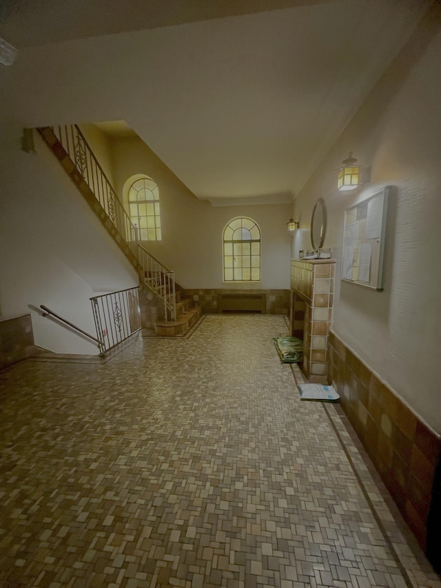 108 Palisade Ave Unit A5, Jersey City, NJ 07306 - unfurnished living room with stairway and a baseboard heating unit