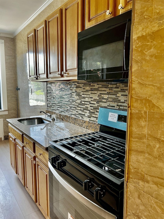 108 Palisade Ave Unit A5, Jersey City, NJ 07306 - kitchen featuring gas stove, black microwave, crown molding, dark stone countertops, and tasteful backsplash