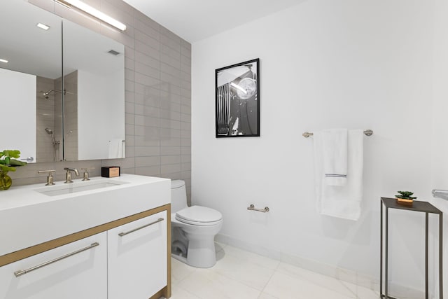 bathroom featuring toilet, tile walls, tile patterned flooring, vanity, and walk in shower