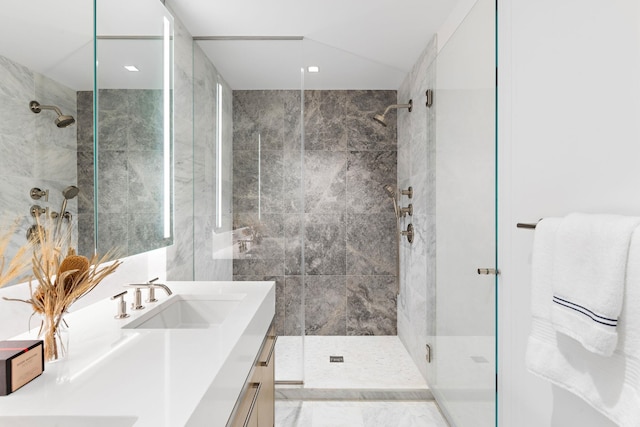 bathroom with a shower with shower door and vanity