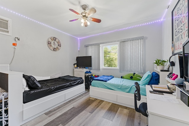 bedroom with ceiling fan and light hardwood / wood-style flooring