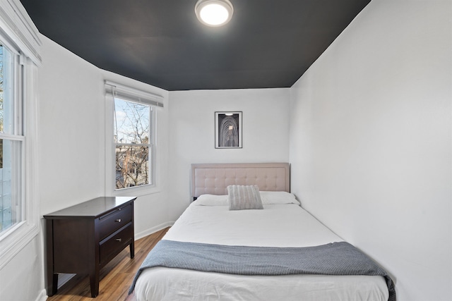 bedroom featuring baseboards and wood finished floors