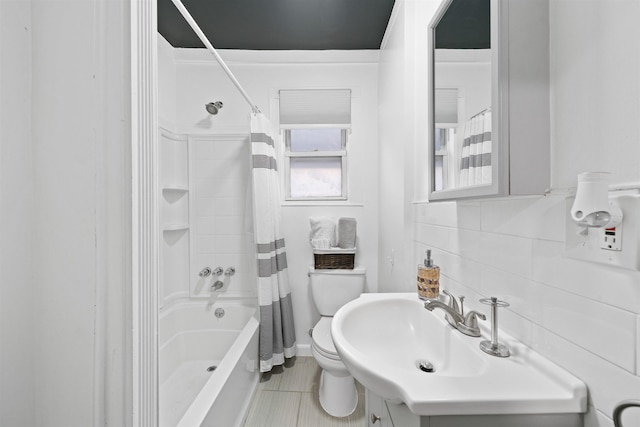 full bathroom with tile patterned flooring, toilet, vanity, backsplash, and shower / bath combination with curtain