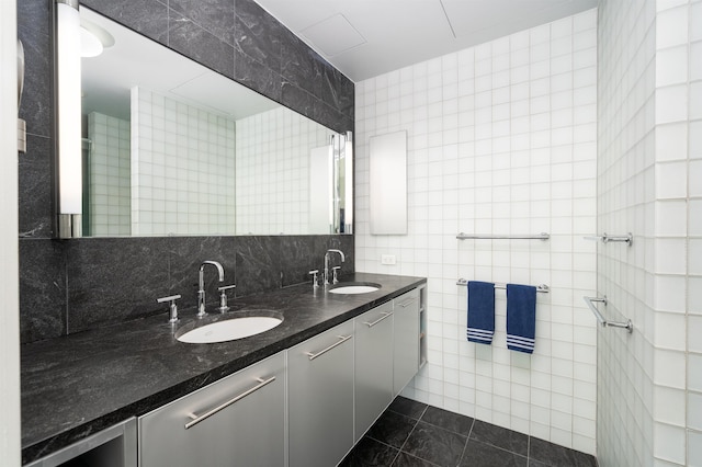 bathroom with vanity, backsplash, tile walls, and tile patterned flooring