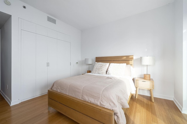 bedroom with a closet and hardwood / wood-style flooring