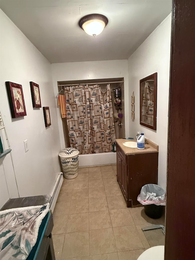 full bathroom featuring a baseboard heating unit, shower / bath combo with shower curtain, toilet, tile patterned floors, and vanity