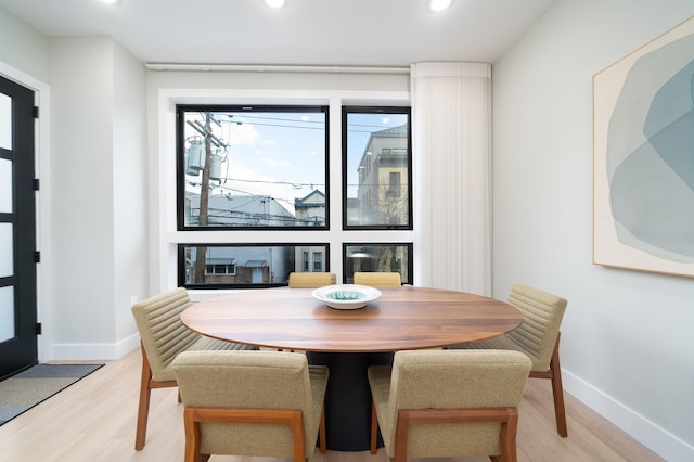 dining area with light hardwood / wood-style floors