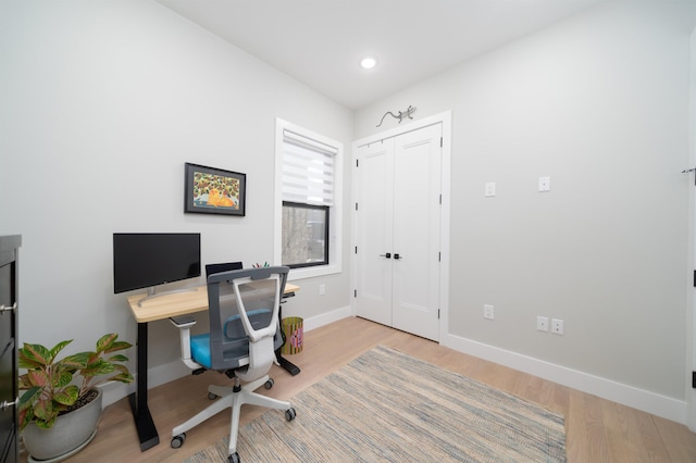 office with light wood-type flooring