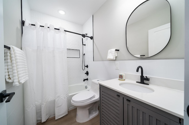 full bathroom featuring hardwood / wood-style floors, vanity, toilet, and shower / bathtub combination with curtain