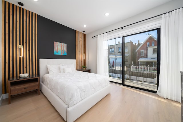 bedroom featuring access to outside and hardwood / wood-style flooring