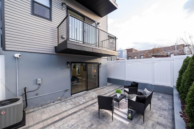 view of patio / terrace featuring central air condition unit and a balcony