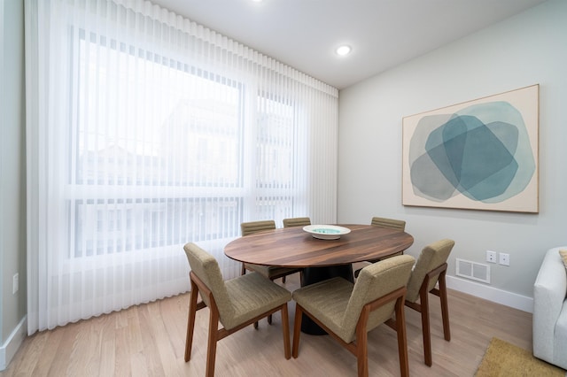 dining space with light wood-type flooring