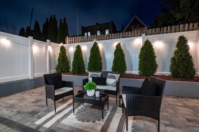 patio at twilight featuring an outdoor hangout area