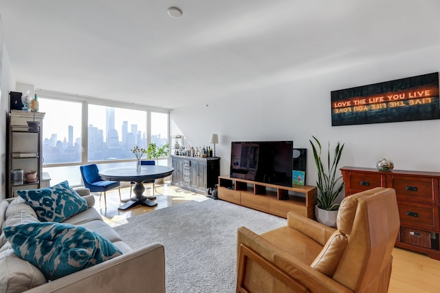 living area with light wood-type flooring and floor to ceiling windows