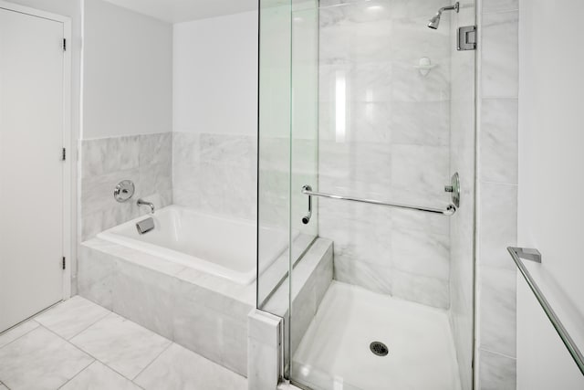 full bathroom with a garden tub and a shower stall