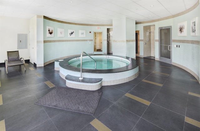 view of pool featuring electric panel and an indoor in ground hot tub