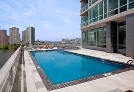 outdoor pool with a city view and a patio