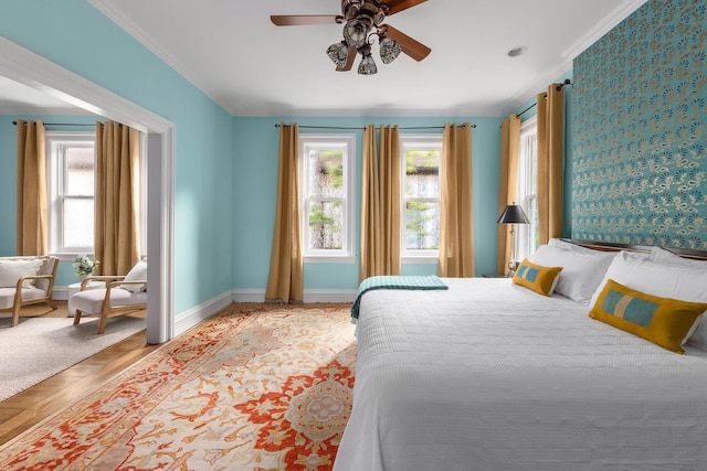 bedroom with crown molding, light parquet flooring, and multiple windows