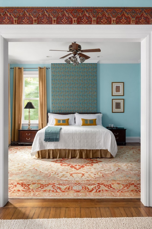 bedroom with ceiling fan and hardwood / wood-style floors