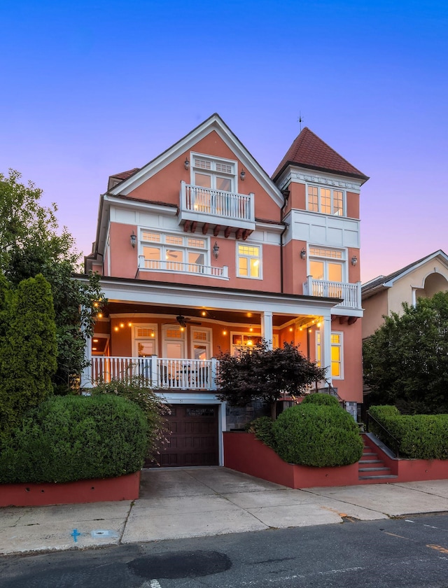 view of front facade with a balcony and a garage