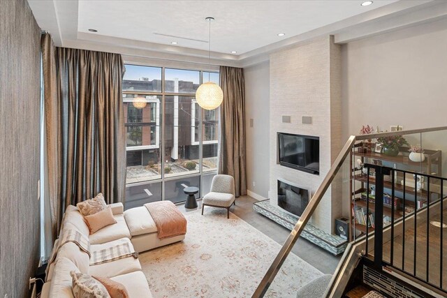 living room with recessed lighting, baseboards, stairs, and a fireplace