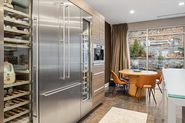 kitchen with recessed lighting, modern cabinets, and built in fridge