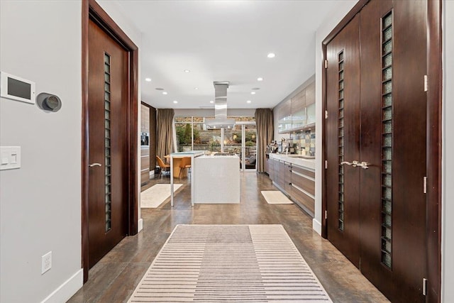 hall with recessed lighting and baseboards