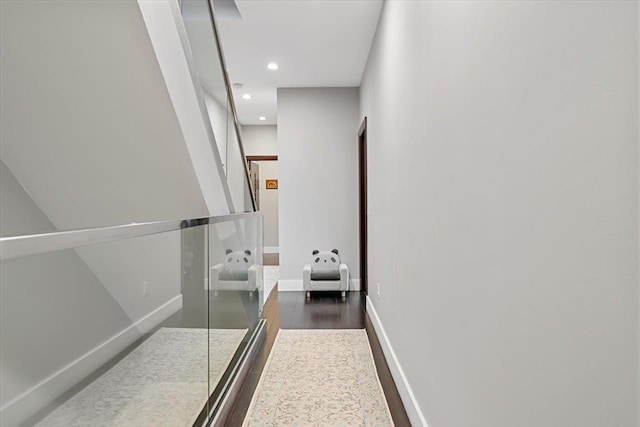 corridor featuring recessed lighting, baseboards, and dark wood-type flooring