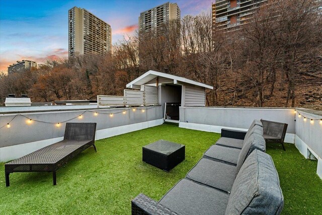 yard at dusk featuring an outdoor hangout area