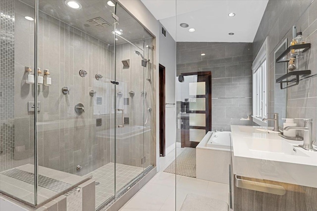 full bath with visible vents, a garden tub, a stall shower, tile patterned floors, and tile walls