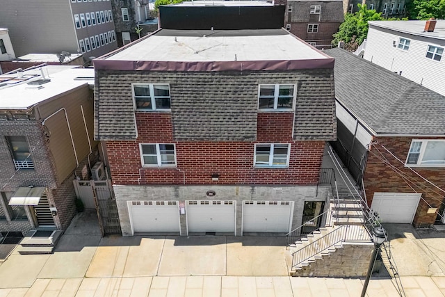 rear view of house with a garage