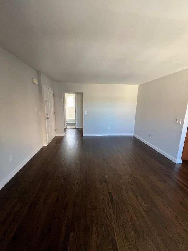 unfurnished living room with dark hardwood / wood-style floors